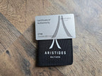Aristides Guitars certificate of authenticity card on a wooden surface
