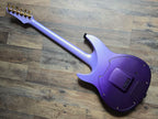 Purple synthetic electric guitar on a wooden floor