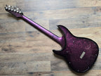 pink and black electric guitar on a wooden surface