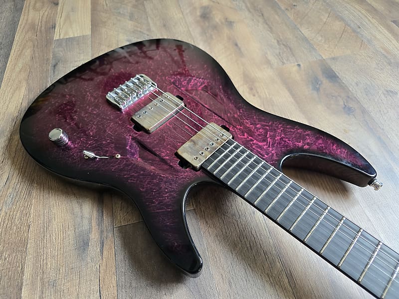 synthetic pink and black guitar with a richlite fretboard