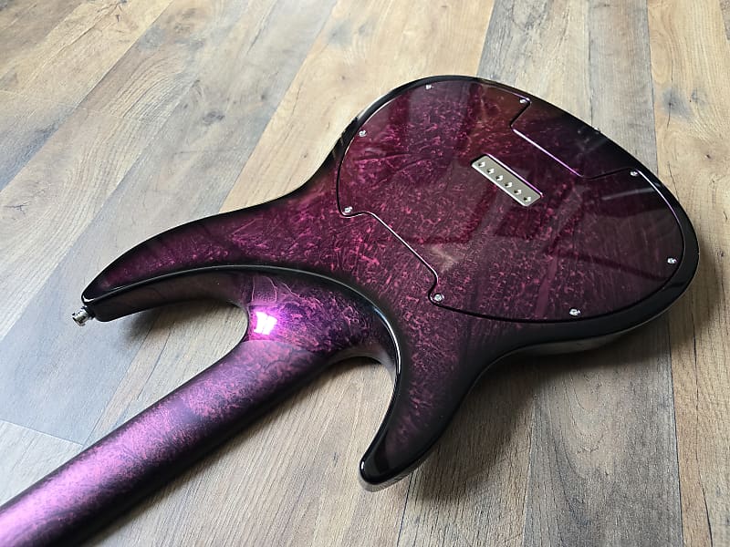 Purple guitar body on a wooden floor