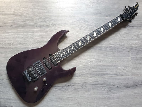 A used Caparison Through and Through TAT II electric guitar in Crimson color with an Alder body, Maple neck, Ebony fretboard, Gotoh Tuners, Gotoh Floyd Rose, and Seymour Duncan Pickups.