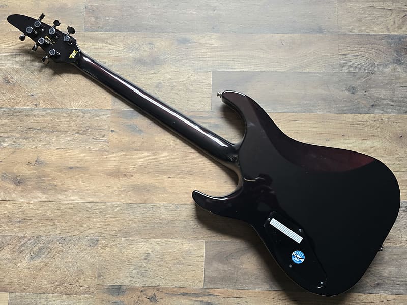 Glossy black electric guitar on a wooden floor