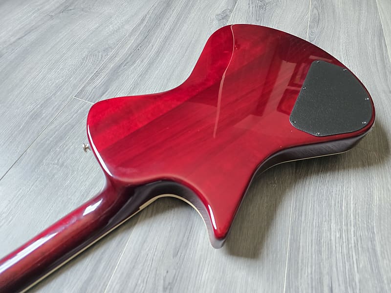 Red guitar body on a wooden floor