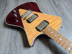 Electric guitar with a maroon finish on a wooden floor