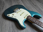 Blue and white electric guitar on a wooden floor