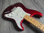 Red electric guitar with white pickups and knobs