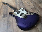 Blue and black electric guitar with a sparkle finish on a wooden floor