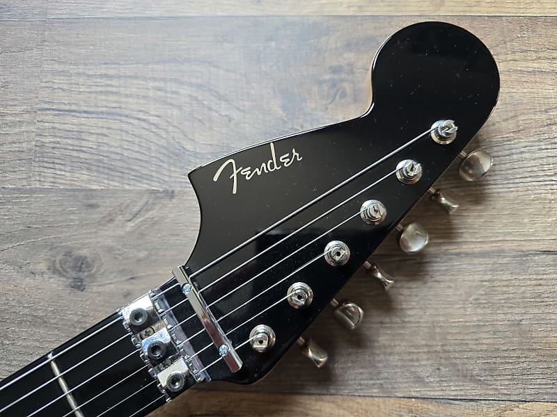 Fender Masterbuilt Jaguar Floyd headstock on a wooden surface