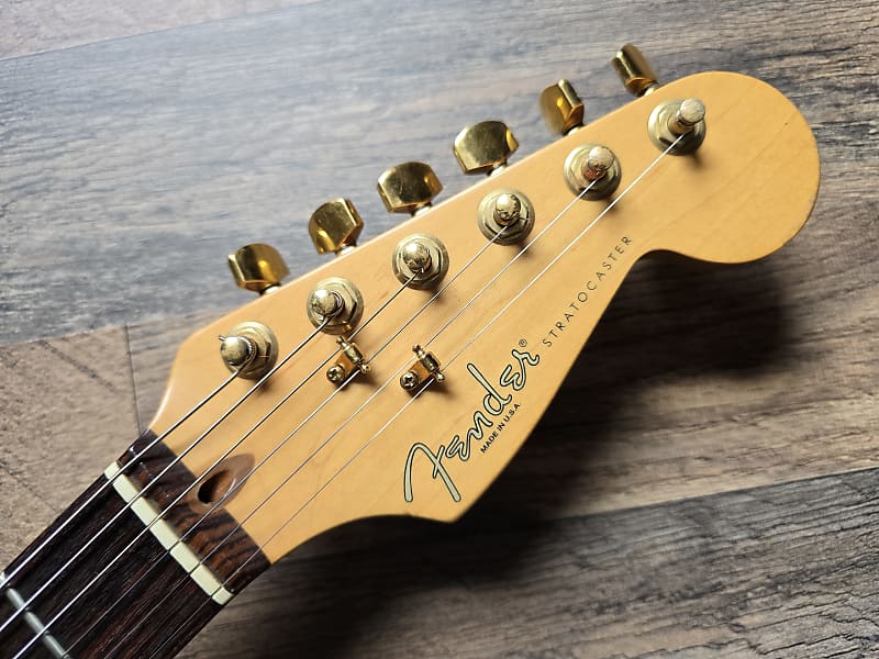 Fender guitar headstock on a wooden surface