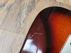 Close-up of a guitar on a wooden floor