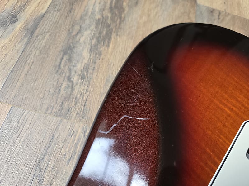 Close-up of a guitar on a wooden floor