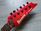 Red Ibanez guitar headstock on a wooden surface