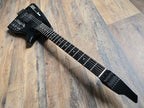 Black Ibanez guitar with an ebony fretboard on a wooden floor