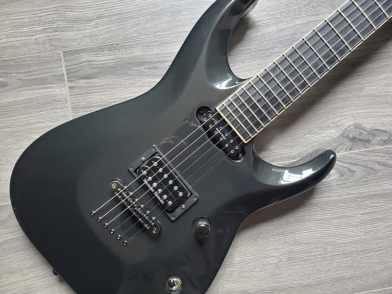 Black electric guitar on a wooden surface