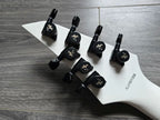 white back of guitar headstock with black tuning pegs and serial number