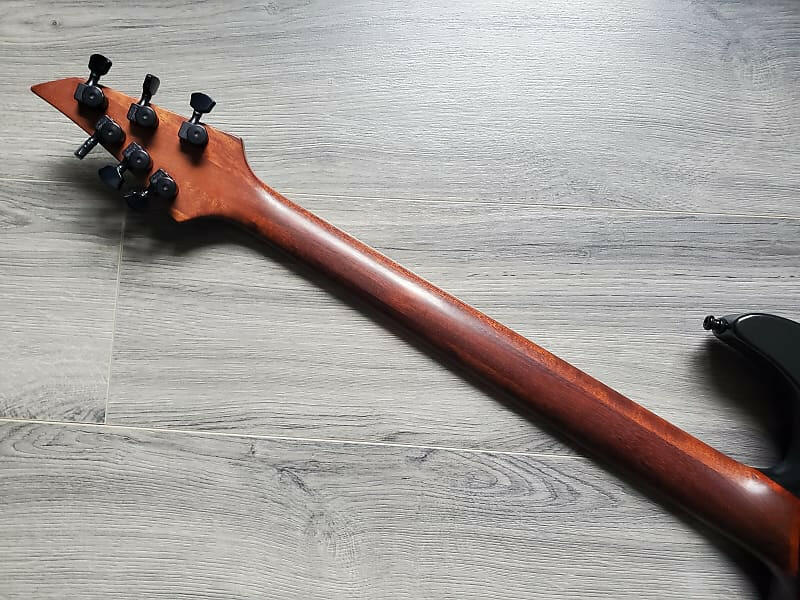 Close-up of a guitar neck on a wooden surface