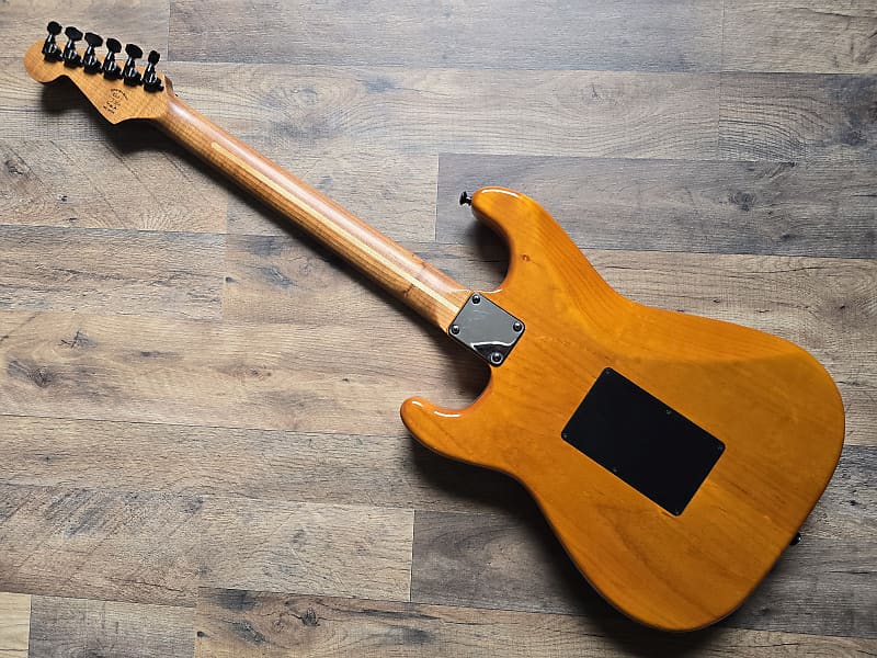 Wooden electric guitar on a wooden surface