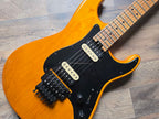 Orange and black electric guitar with black pickups and hardware