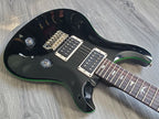 Black electric guitar with gold hardware and a rosewood fretboard