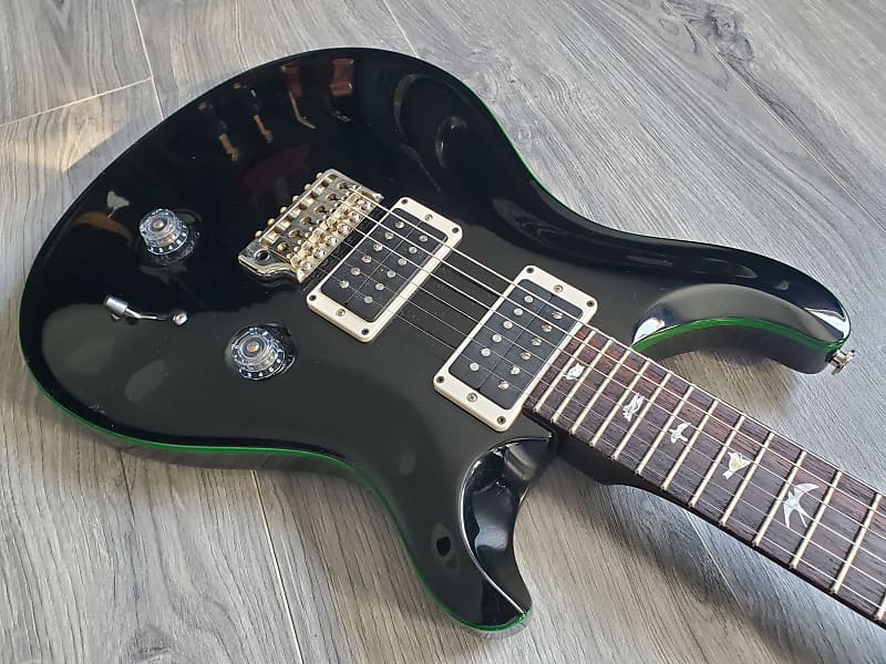 Black electric guitar with gold hardware and a rosewood fretboard