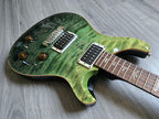 Green electric guitar on a wooden floor