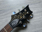 Guitar headstock with 'P22' branding on a wooden surface