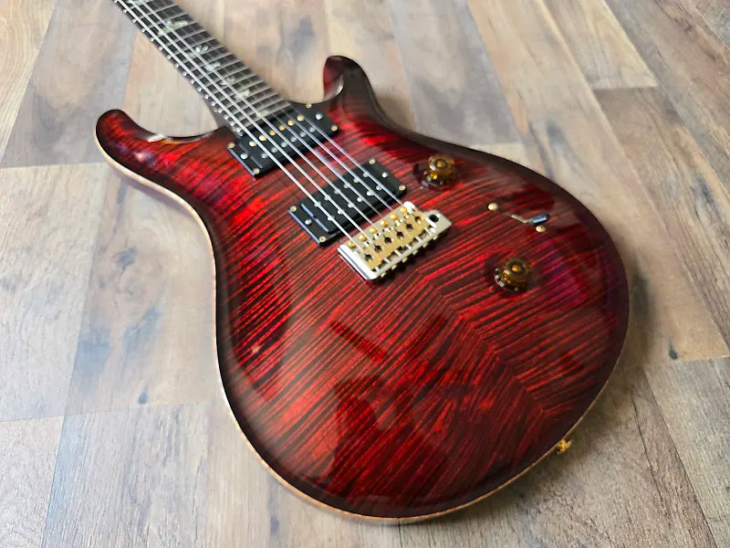 PRS electric guitar with a red glossy body and gold hardware