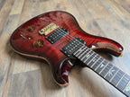 Red electric guitar with a rosewood fretboard, PRS locking tuners and pickups