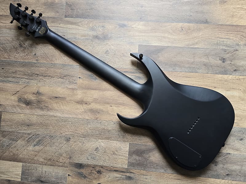 back of electric guitar lying on a wooden surface