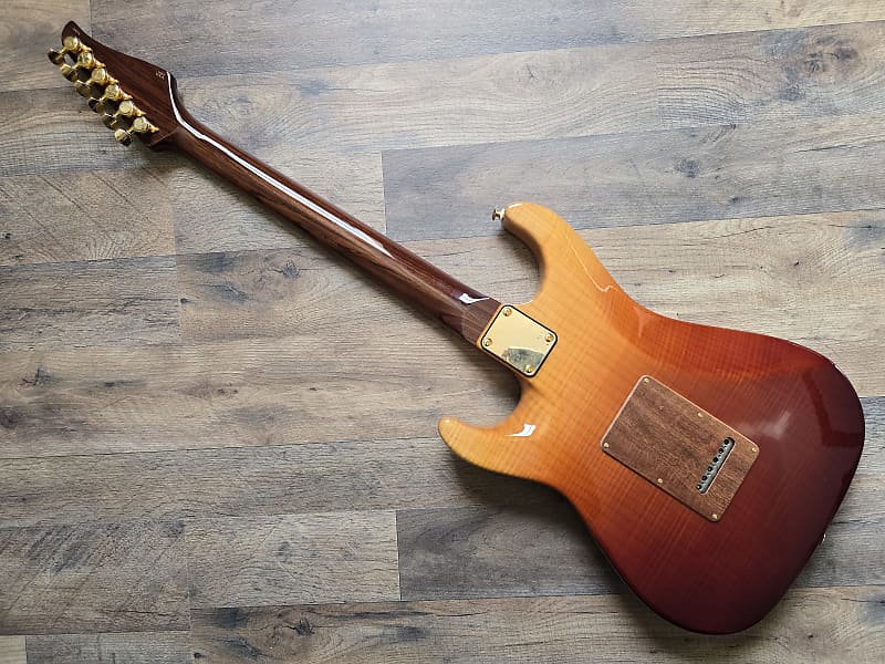 Electric guitar with a sunburst finish on a wooden floor