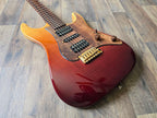 Electric guitar with a red and orange sunburst finish on a wooden floor