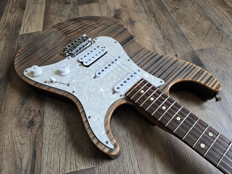 Guitar body with wooden finish and white pickups