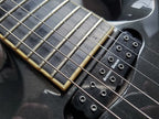 Close-up of a guitar's neck and bridge with Seymour Duncan pickups and a serial number.