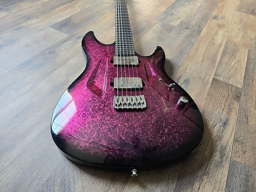 Pink and black electric guitar on a wooden floor