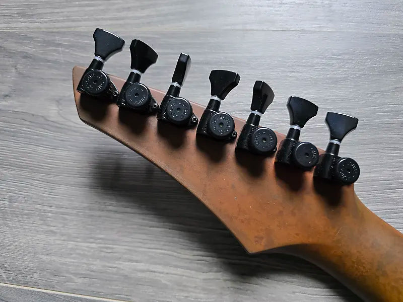 Guitar tuning pegs on the back of a guitar headstock 