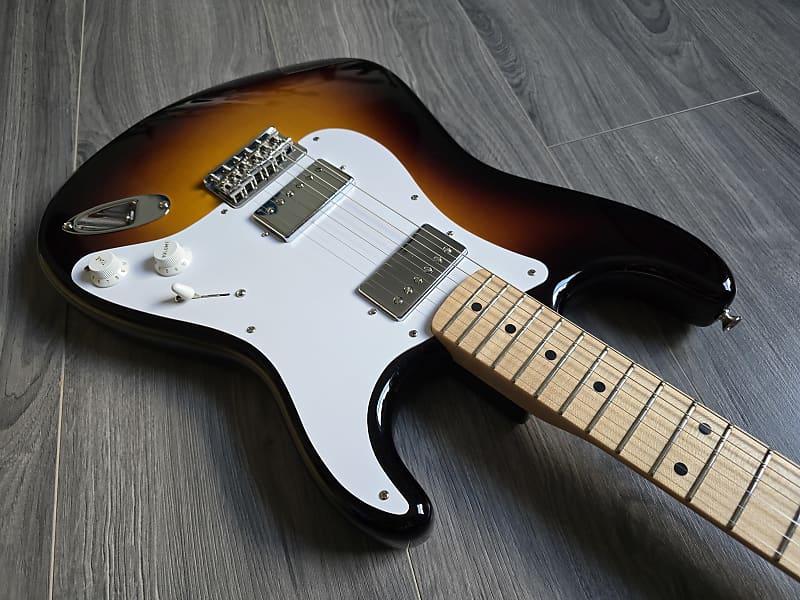 Sunburst electric guitar on a wooden floor