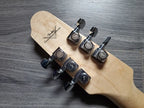 guitar headstock with metal tuning pegs and 'Fender' branding