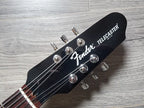 Fender Telecaster guitar headstock on a wooden surface