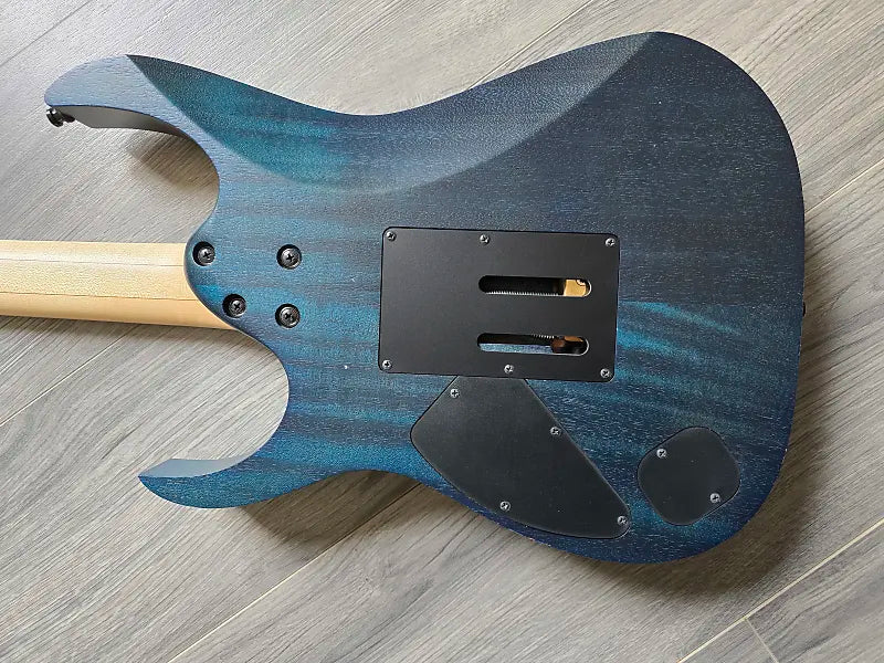 Blue electric guitar body on a wooden floor