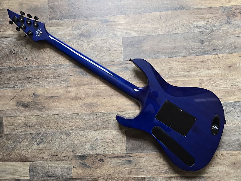 back view of blue electric guitar on a wooden floor