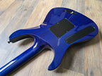 Back of blue guitar body on a wooden surface