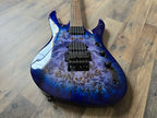 Blue marbled electric guitar displaying bridge and pickups on a wooden floor