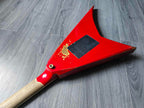 back of a red electric guitar body on a wooden surface