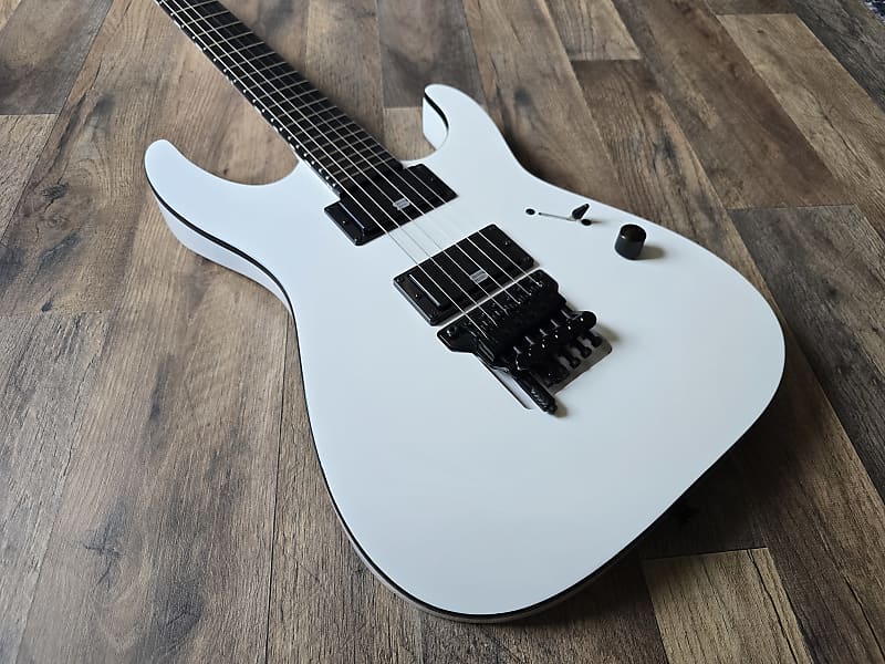 white electric guitar with black Jackson bridge and Seymour Duncan pickups