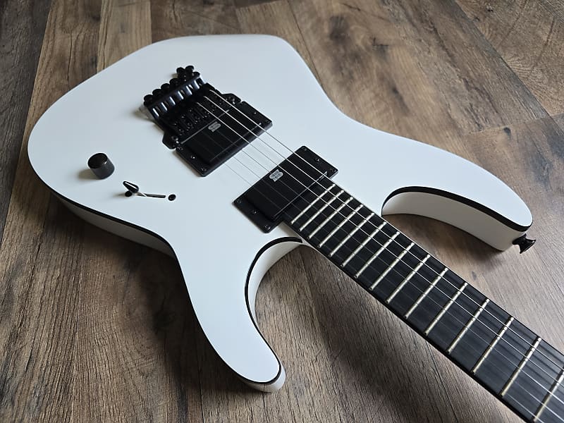 white electric guitar with ebony fretboard and black hardware