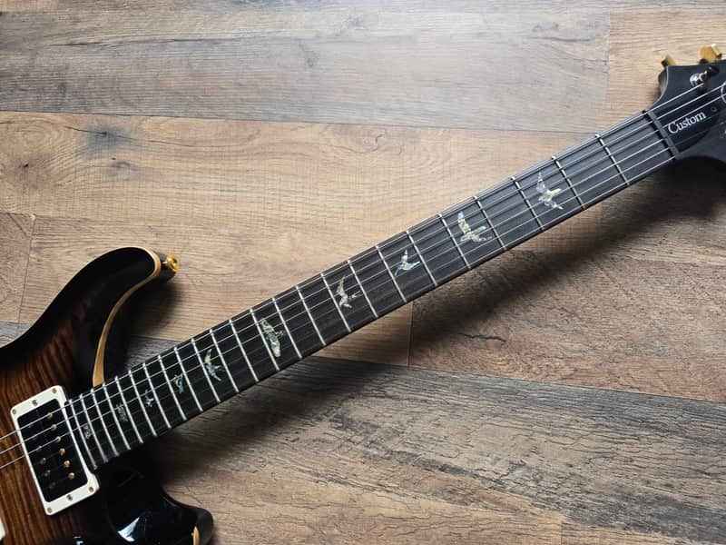 Close-up of PRS Custom 24 bird inlays and premium fretboard detail
