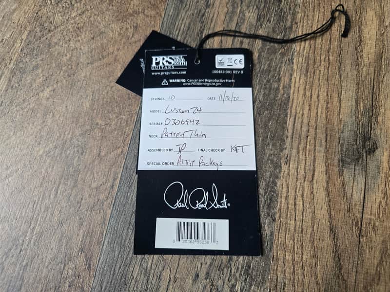 Product tag with 'PRS' branding on a wooden surface