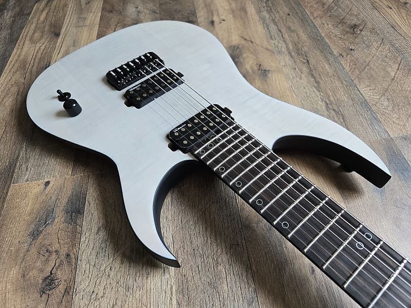 White electric guitar with ebony fretboard