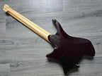 Deep maroon colored electric guitar face down on a wooden surface.